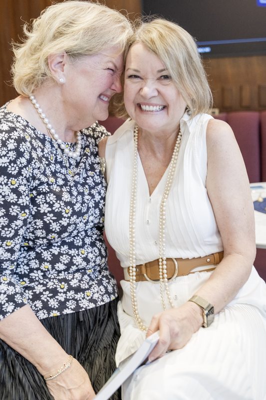 Author Cynthia Currence laughing with a guest at her book launch