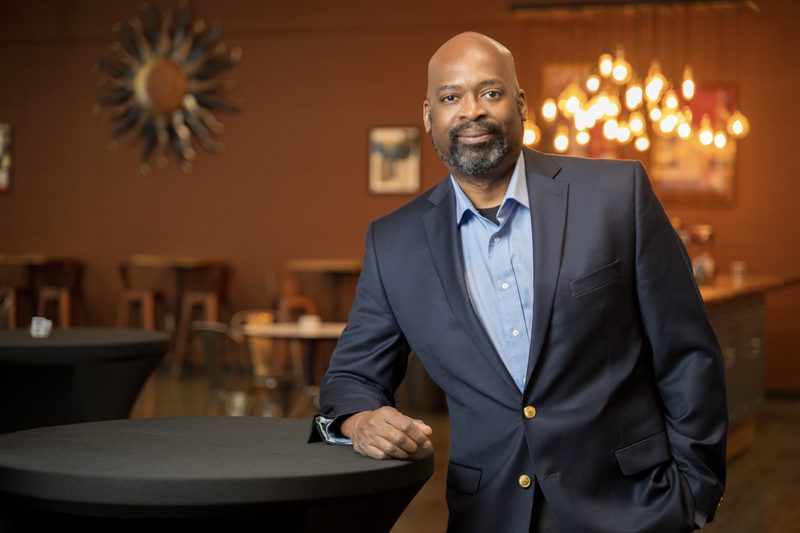 Karl Barham of Transworld Business Advisors, on-location portrait in a warmly lit venue