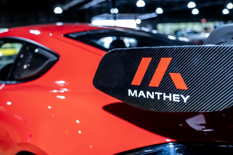 Manthey badge on a red Porsche rear wing